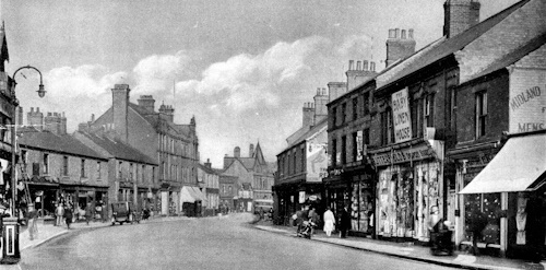 This image: a historic photograph of the High Street.
						The map: the map shows the Project Area along with some map markers to
						of photographs of current and historic architecture of the town. The map
						also shows the national cycle network and the local bus route and bus stops.